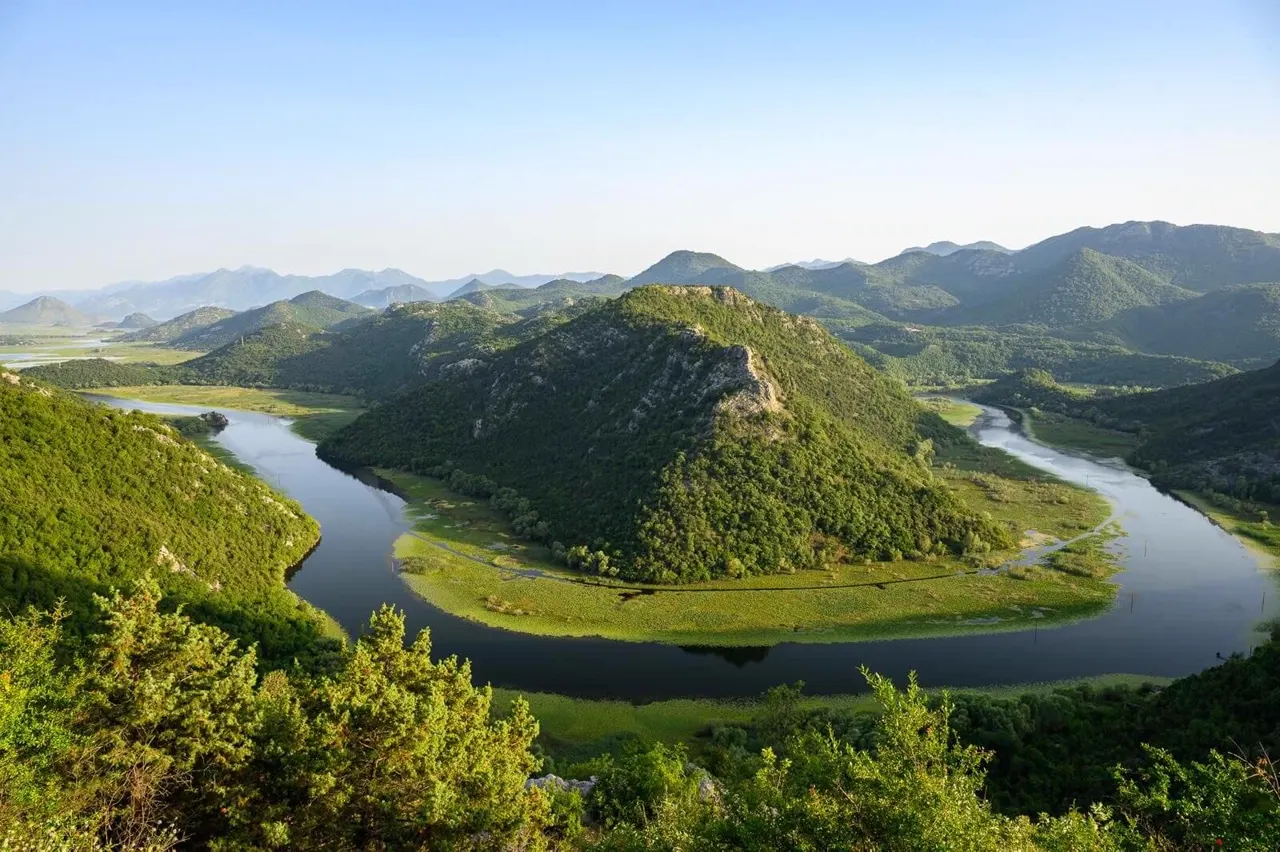 Boat on the calm water of Lake Skadar seen from above