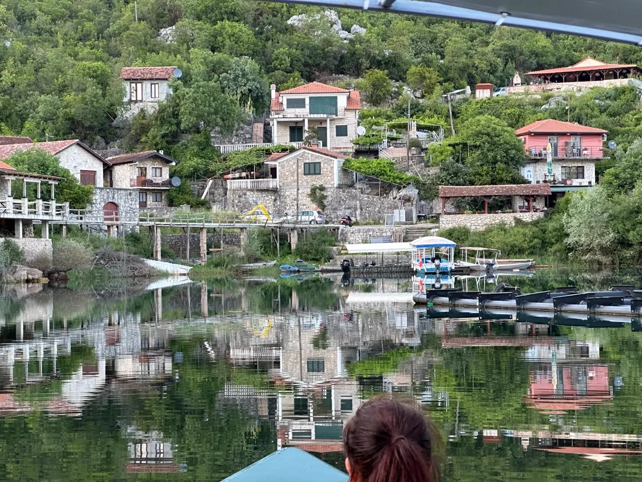 Stone houses of Karuč village reflected in Lake Skadar